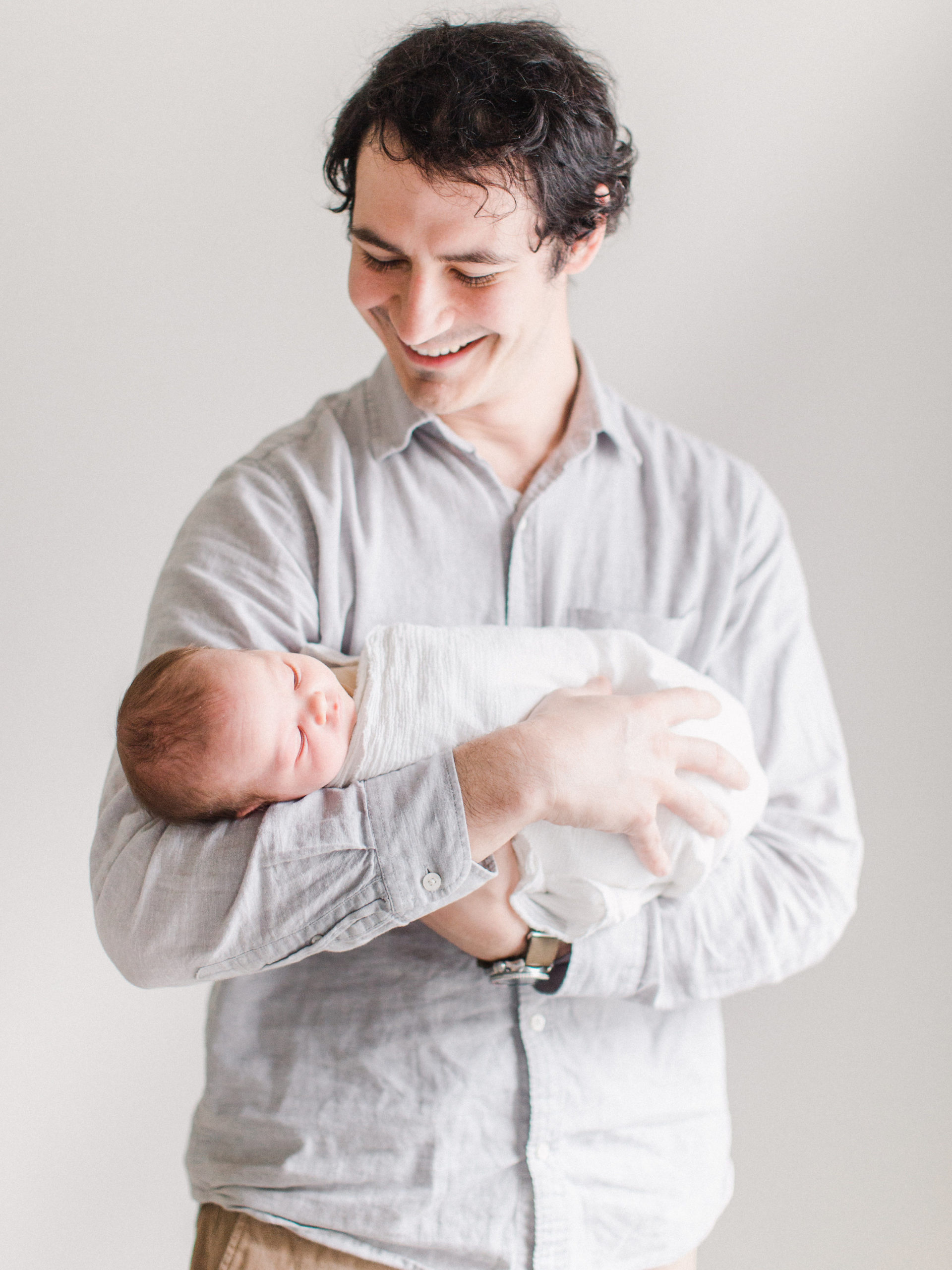 Simple portrait of dad with newborn