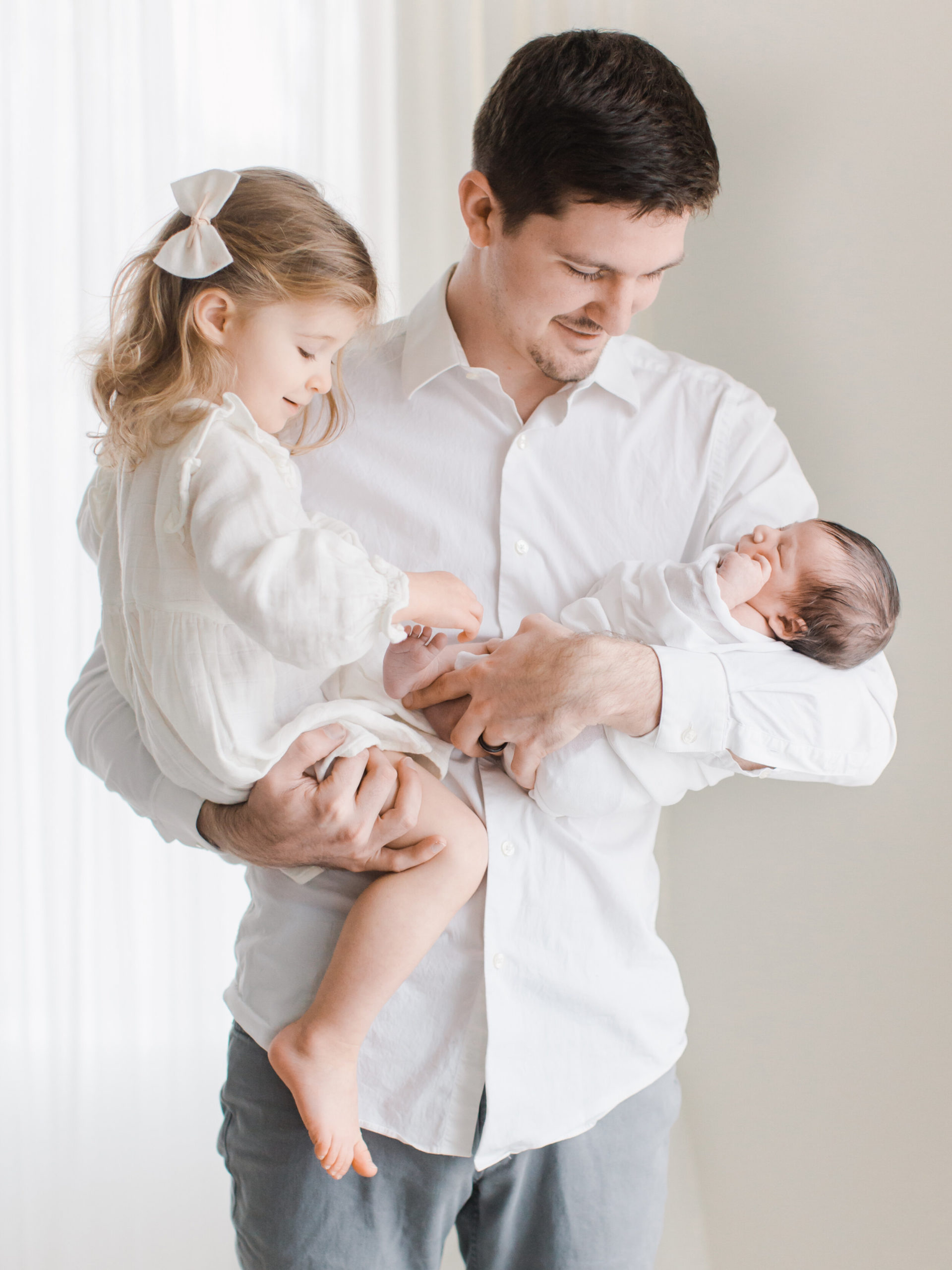 Dad with toddler and newborn during photo session