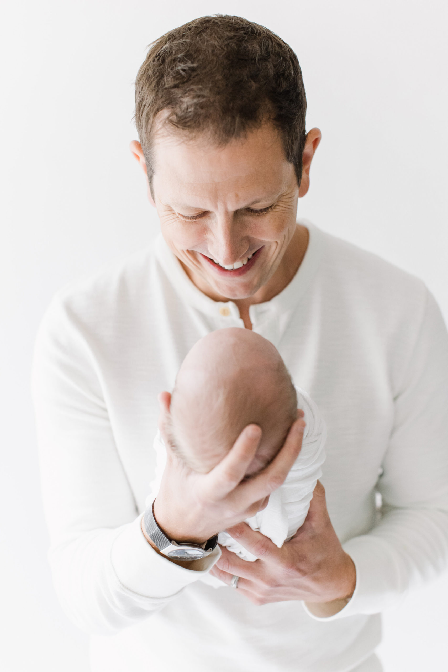 joyful dad and newborn portrait