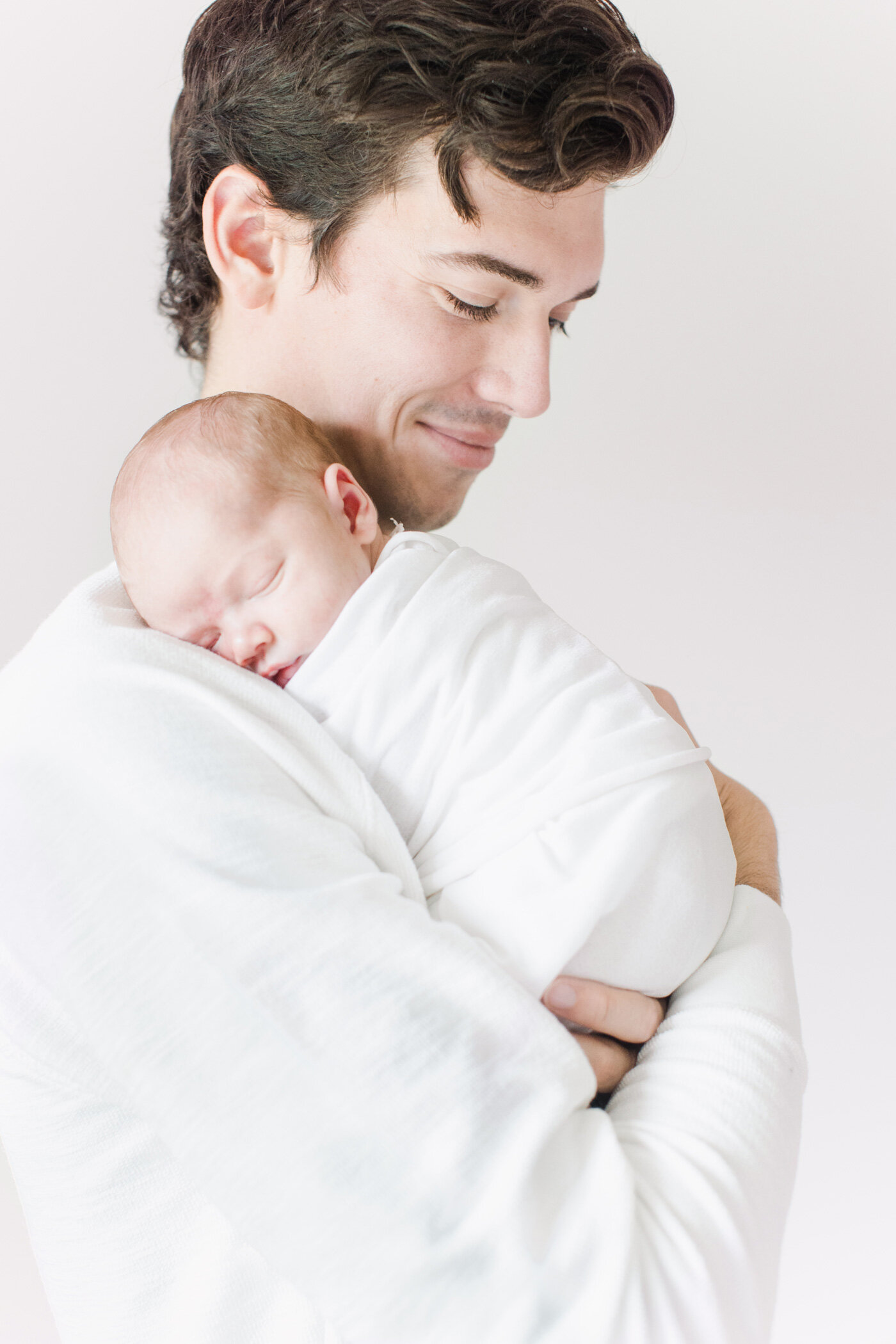 dad with newborn baby simple light and airy