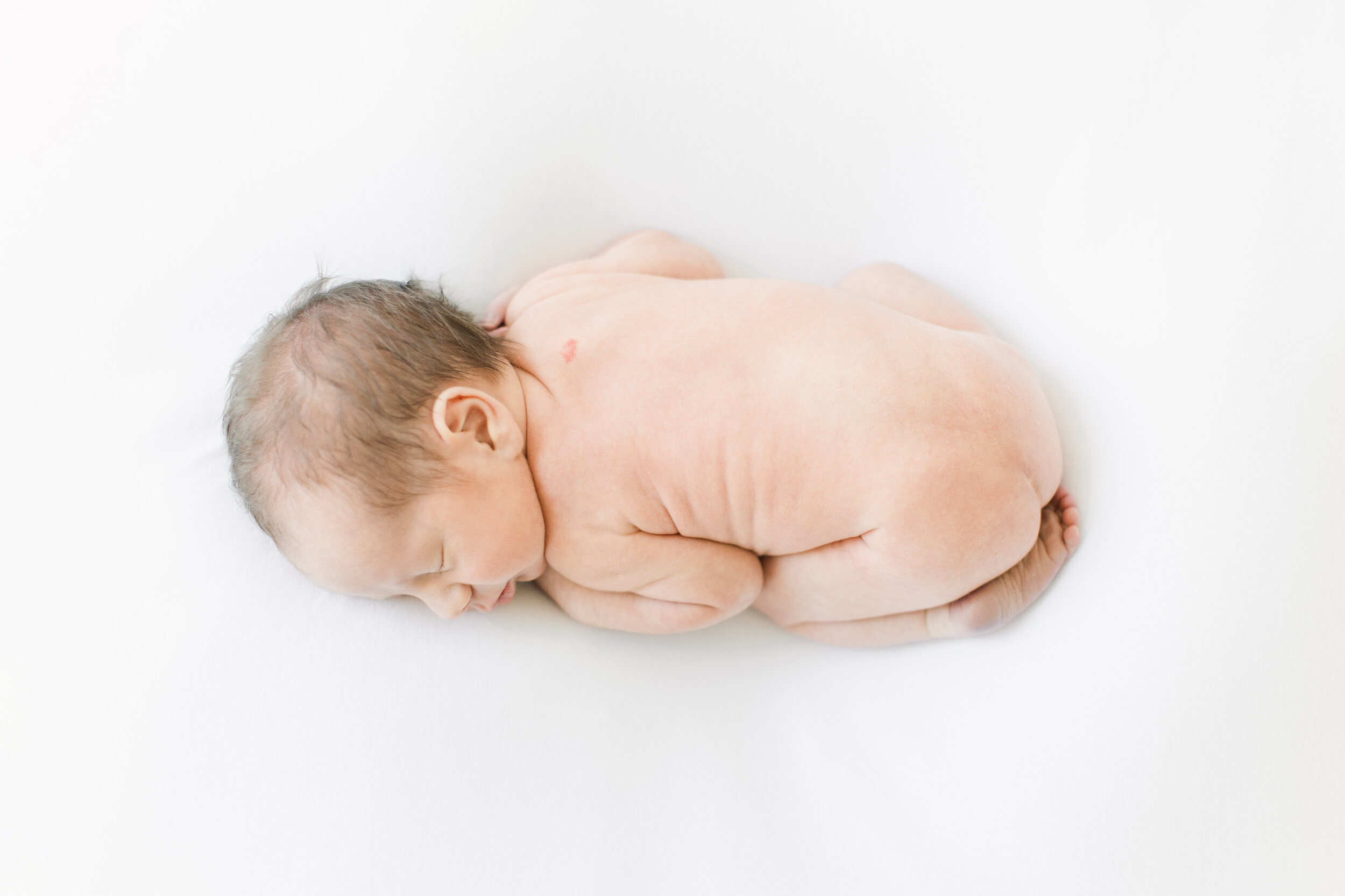 unique newborn photography of baby alone