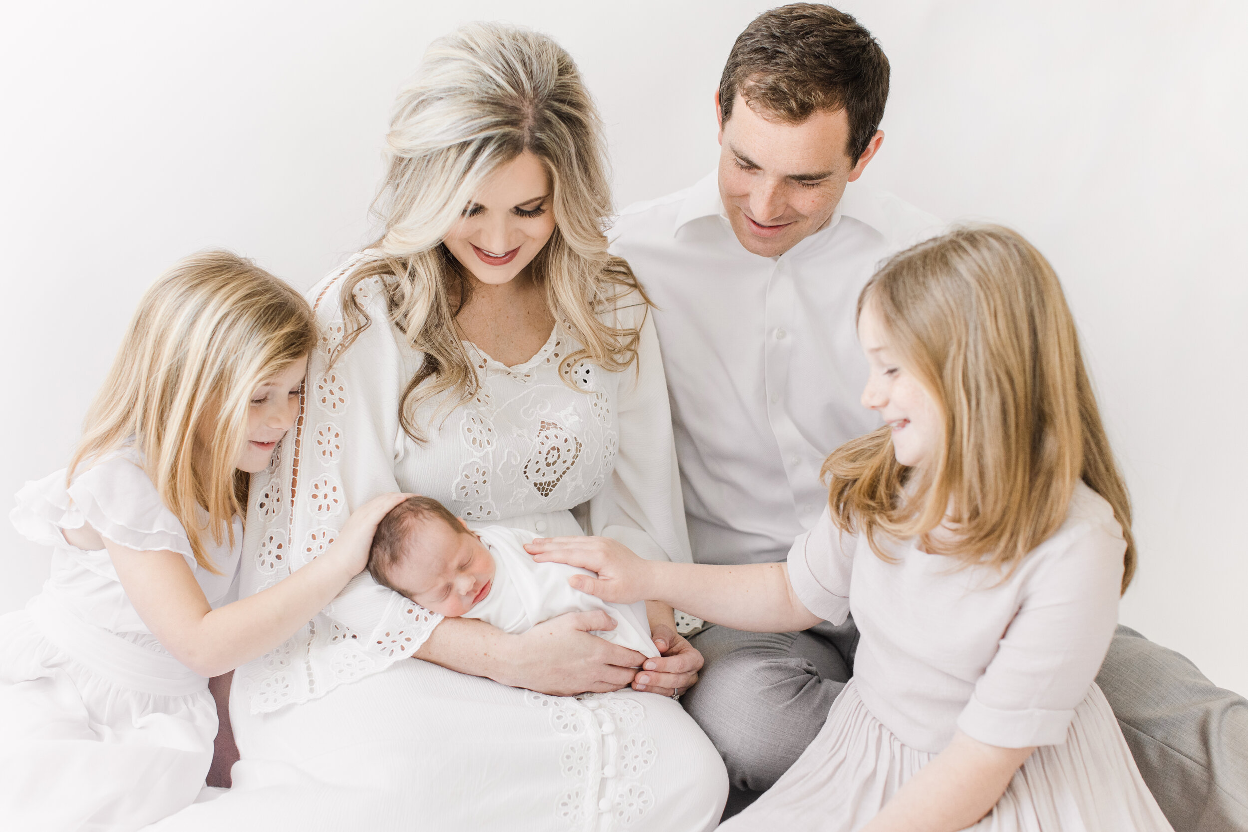 candid newborn photo with family of five